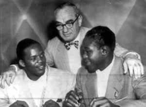 Gil Turner and Kid Gavilan flabk promoter Herman Taylor Gil Turner and Kid Gavilan flank promoter Herman Taylor